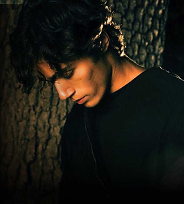 Brixton Berry of BR!X, moody dark portrait against a tree