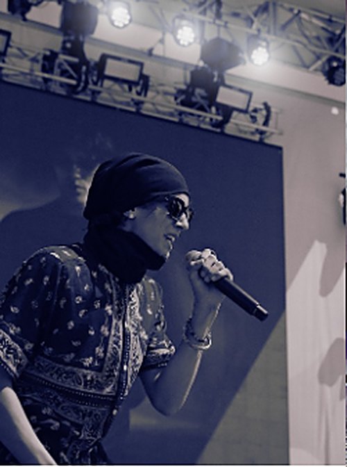 BR!X performing live with a microphone at the World Surf League US Open